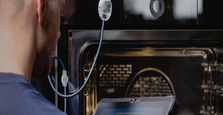 V-Zug technician in front of oven